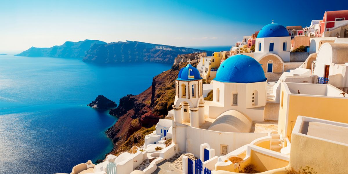 Which sea surrounds Santorini, the Greek island famous for its blue-domed churches