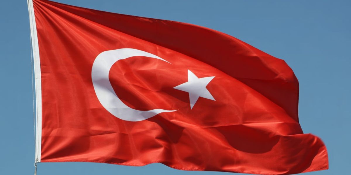 Which country has a red flag with a white crescent moon and star